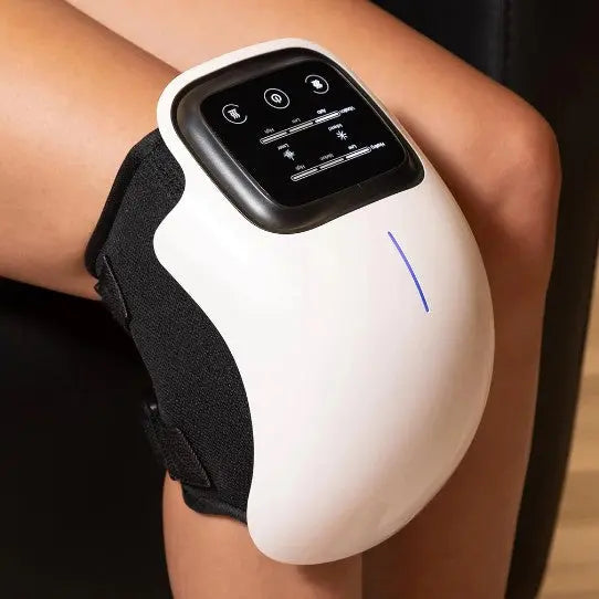 A woman using SUCCORO KneeAid massager to relieve knee pain sitting at home